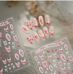 Detail of French floral nail stickers with pink roses and white bow designs