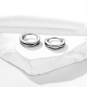 Retro silver triple layered round hoop earrings on white stone minimalist jewelry