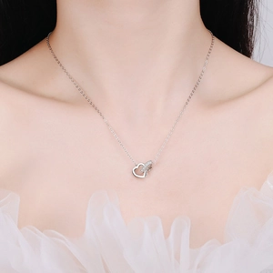 925 sterling silver heart pendant necklace with moissanite crystals on a female model