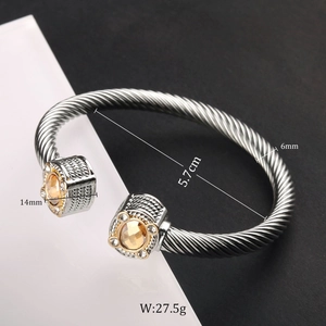 Detail view of steel cable cuff bracelet showing dimensions and yellow stone inlay
