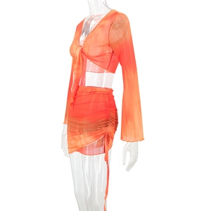 Detailed side view of orange tie-dye mesh set showing drawstring ruched skirt details