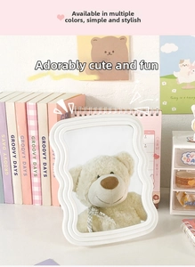 Detail of cream wavy frame makeup mirror with clear reflection in aesthetic desktop setup