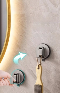 Close-up of vacuum suction cup hook in grey finish on a marble bathroom wall
