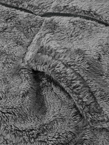 Macro detail of soft grey double-sided fleece fabric texture and premium metal zipper