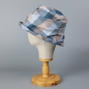 Detail shot of the blue checkered bucket hat fabric showing lightweight cotton linen texture