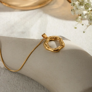 18k gold plated stainless steel necklace featuring a hammered irregular round pendant