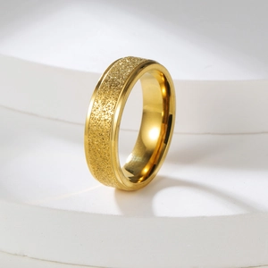 Detail of 2mm golden stainless steel ring featuring sandblasted surface and polished edges