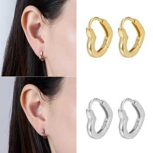 Close-up of S925 sterling silver heart hoop earrings in gold and silver finishes