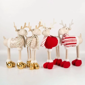 Set of four plush Christmas reindeer figurines in red and gold patterns on white background