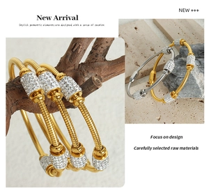 Detail of 18K gold and silver snake texture bracelets with micro-pave zirconia stones