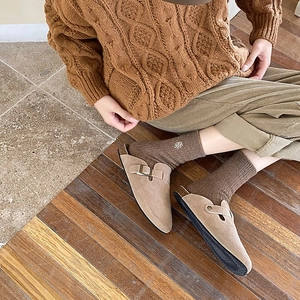 Cozy khaki suede mule shoes with metal buckle detail worn in a warm Mori style setting