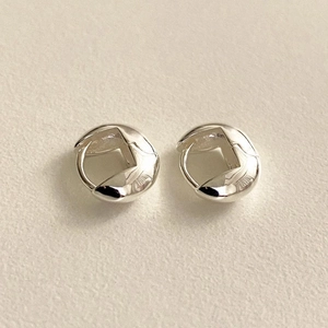 Close-up of minimalist S925 sterling silver oval hoop earrings with a twisted design