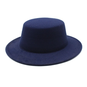 Close-up detail of dark blue flat-top wool felt fedora showing premium texture and finish