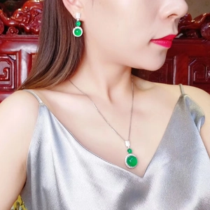 Elegant green chalcedony jewelry set including necklace and earrings on a model