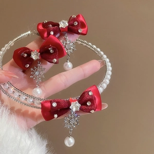 Detail of red bow jewelry set featuring sparkling rhinestones, pearls and snowflakes