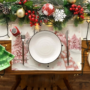 Flat lay of Christmas placemat with snowman design on a wooden table with ceramic plate