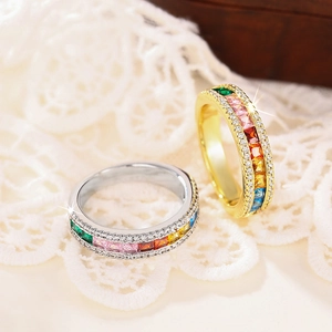 Macro shot of colorful eternity rings with rainbow square-cut stones and pave zircons