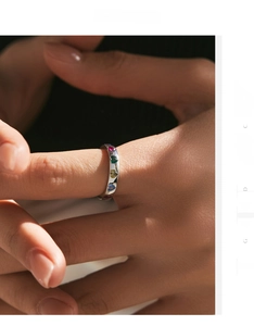 Detail of s925 silver ring featuring colorful heart-shaped stones on model hand