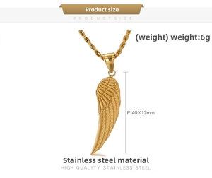 Macro detail of gold angel wing pendant in stainless steel with 40x12mm dimensions
