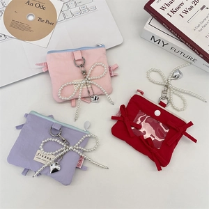 Detailed shot of bowknot card holders in pink, purple and red with pearl pendants