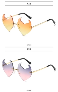 Detail of rimless devil heart shaped sunglasses with metal temples at a 45 degree angle