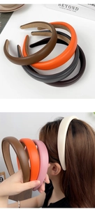 Multiple colors of PU leather sponge headbands shown in a flat lay and worn by a model