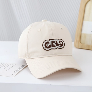 Close-up of cream cotton baseball cap with GELD letter embroidery and curved brim