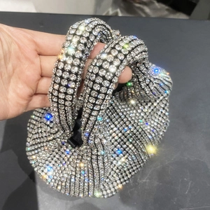 Close-up of sparkling rhinestone bucket bag with crystal handle for evening parties