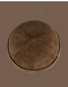 Detail of dark brown corduroy docker cap showing thick texture and six color options
