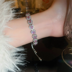 Detail of pink heart-shaped crystal bracelet with micro-paved diamonds on adjustable chain