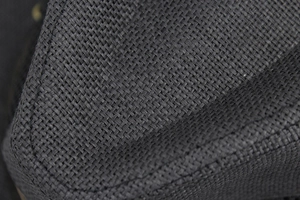 Macro detail of breathable black mesh straw fabric showing woven texture and stitching