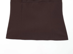 Macro detail of chocolate brown top showing delicate stitching and plain weave fabric texture