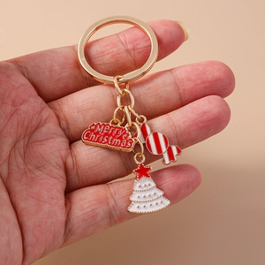 Christmas keychain with gold ring, candy cane, white tree and Merry Christmas plaque