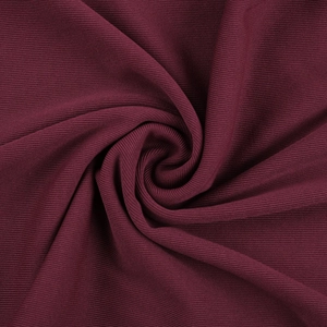 Detailed macro texture of burgundy ribbed knit fabric showing soft vertical patterns