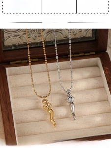 Detail of PVD plated stainless steel Italian horn pendants on bead chains in gold and silver