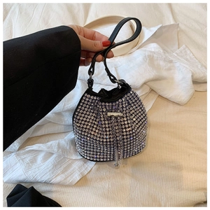 Close-up of a black bucket bag with sparkling silver rhinestones and tassel chain detail