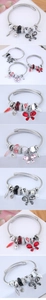 Detail of stainless steel spiral bead bracelet with crystal beads and butterfly charms