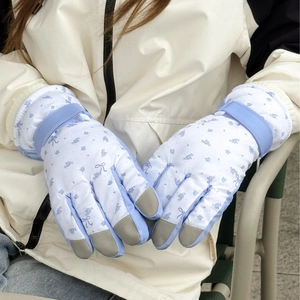 Insulated winter ski gloves with blue floral print and touchscreen fingers for outdoor use