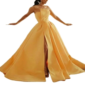 Elegant yellow satin strapless evening gown with high slit and voluminous A-line skirt