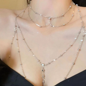 Silver multi-layer body chain with delicate bead accents on model neck and chest