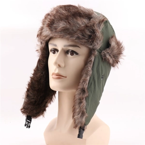 Detail of dark green trapper hat featuring thick brown faux fur lining and ear flap buckle