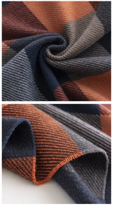 Close-up detail of soft checkered cashmere feel scarf in orange, navy, and grey pattern