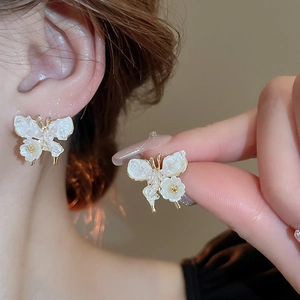 Elegant white butterfly and flower stud earrings with golden metallic accents for women