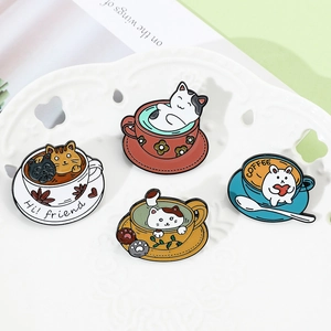 Detailed view of four colorful cartoon cat and bunny coffee cup enamel alloy pins on a plate