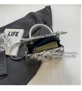 Internal view of a silver sequin handbag showing space for a phone and long wallet