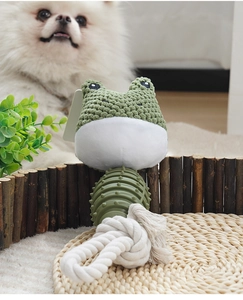 Detail of durable green TPR and cotton rope dog chew toy on a natural straw mat