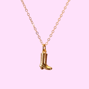 Retro style 18k gold plated cowboy boot pendant necklace for women on pink background