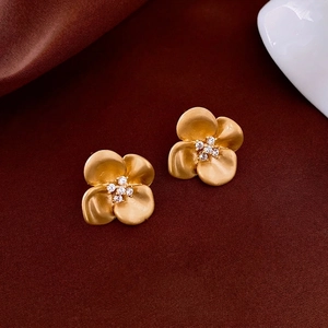 Matte gold floral stud earrings with sparkling cubic zirconia centers for women