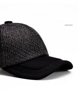 Detail of black woven baseball cap featuring a curved foldable brim and mesh fabric