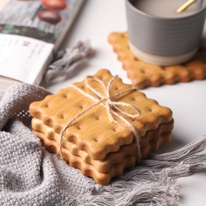 Detail of cookie-shaped solid wood coasters tied with twine in a cozy home setting